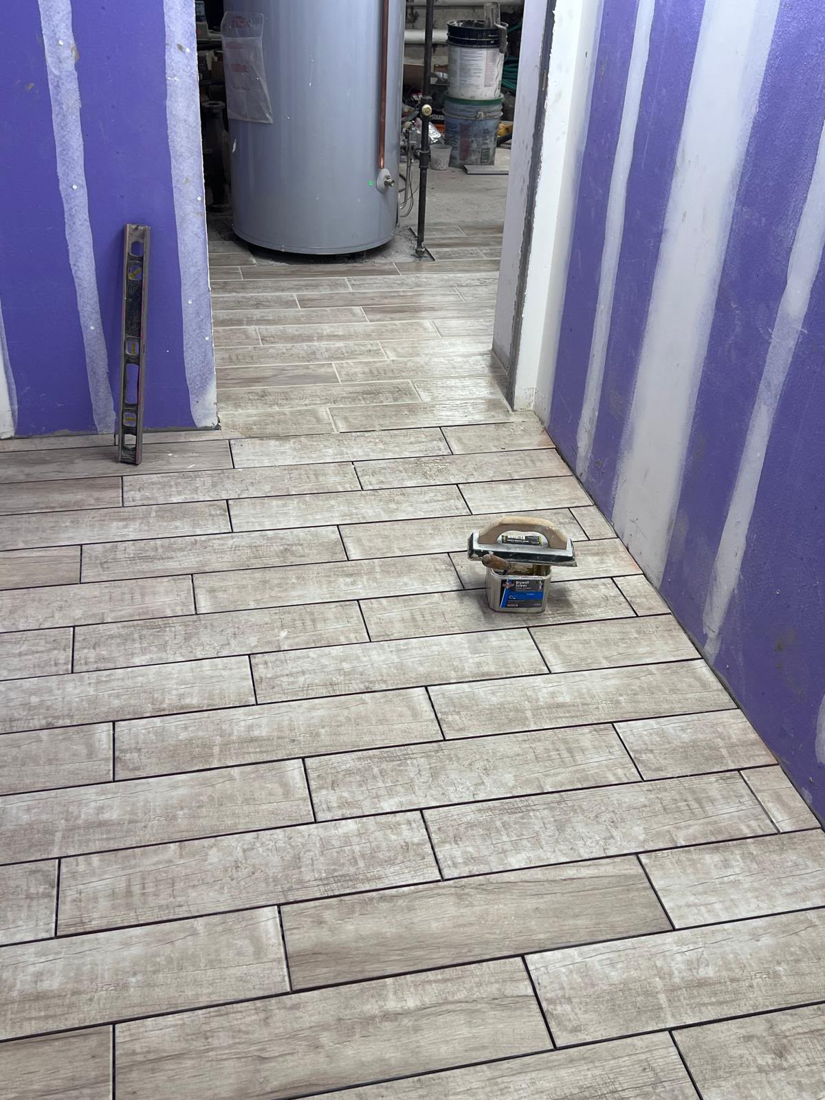 Precision wood-grain porcelain tile floor installation with level joints by LQJ General Construction in East Northport NY