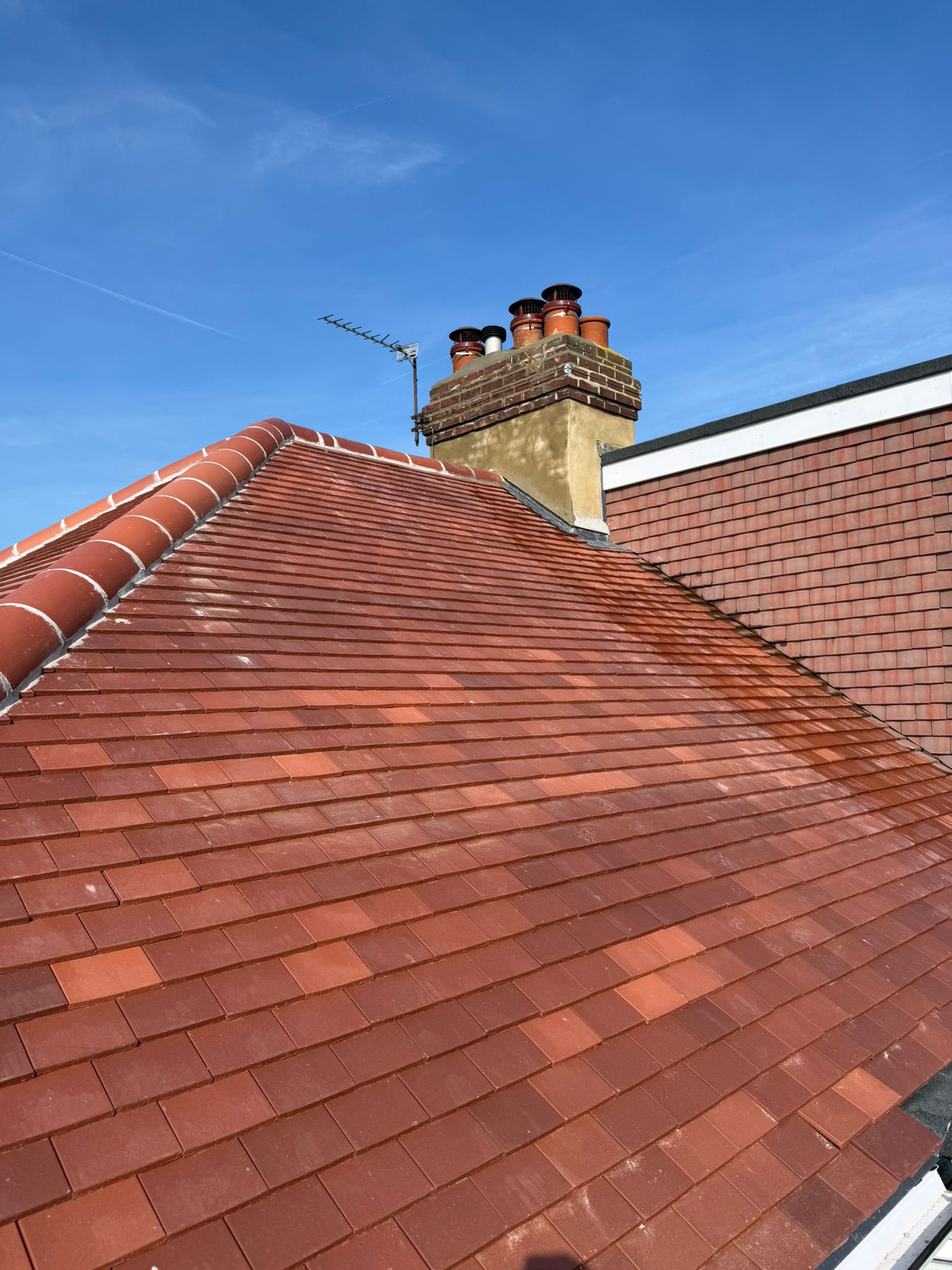 Plain clay tile roof with ridge capping, tile hanging and restored chimney pots