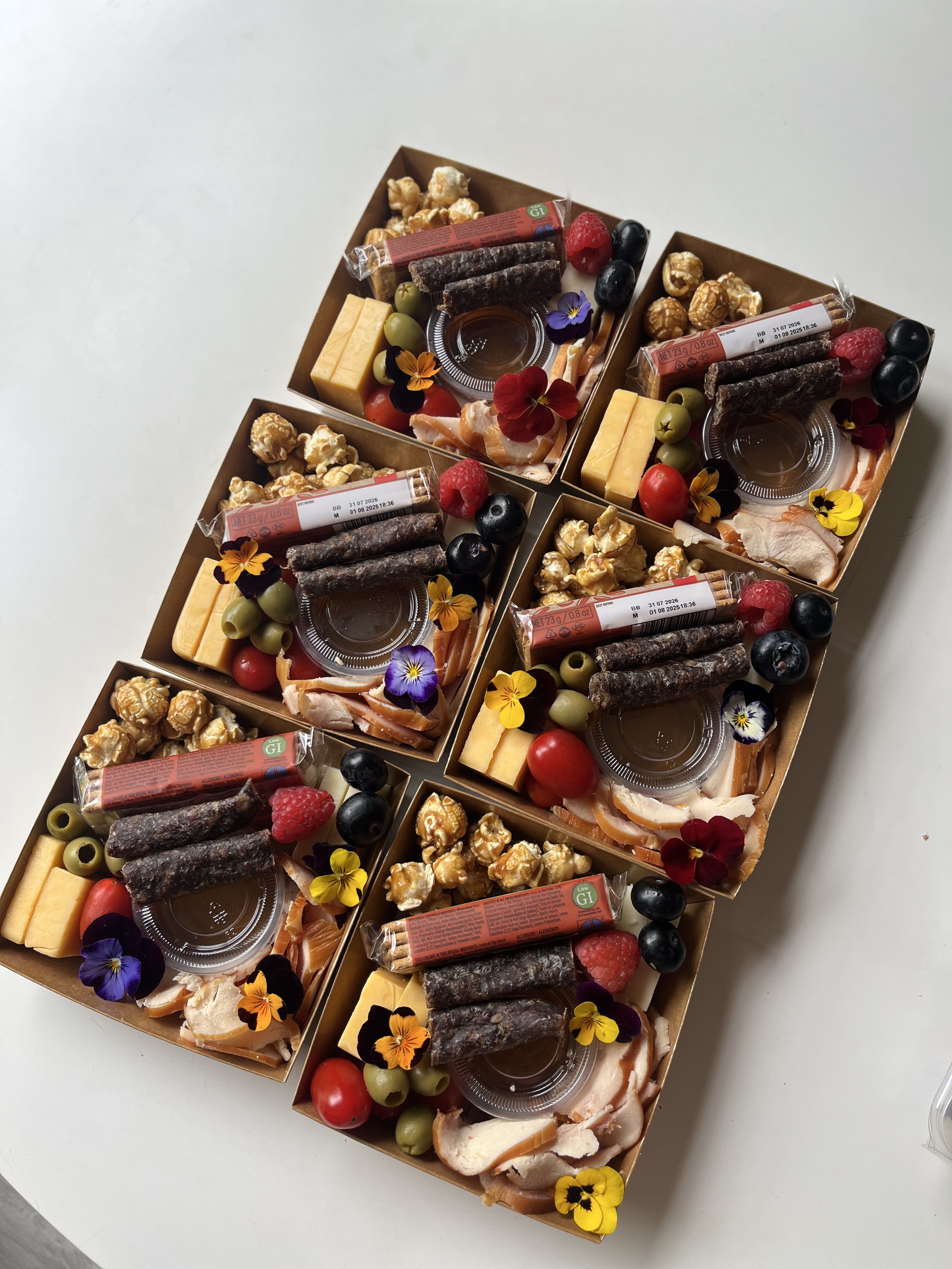 An array of beautifully packed Nibble & Nest charcuterie boxes