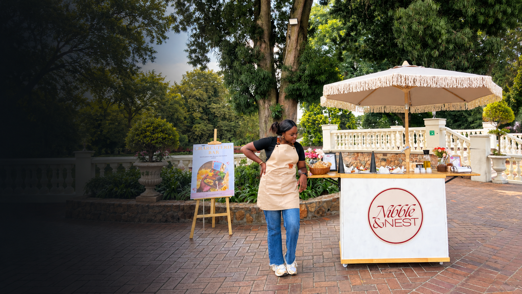 Nibble & Nest owner and signature branded cart with fringed parasol