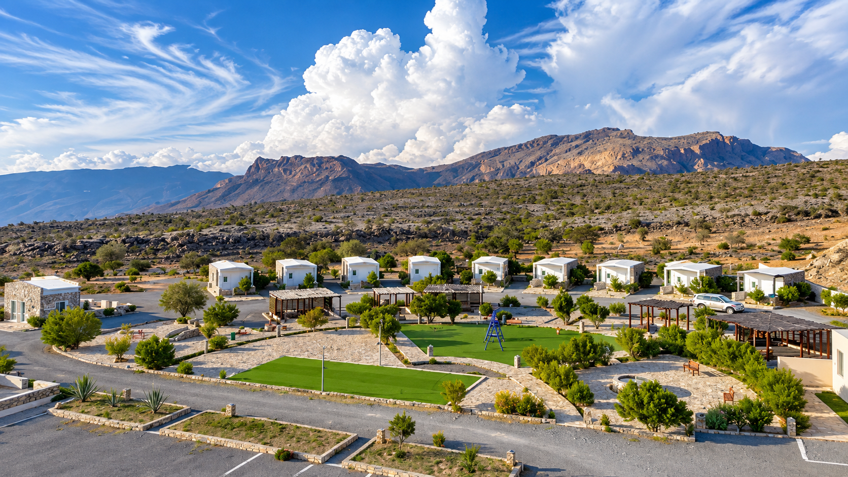 Jebel Shams Resort chalets with blue sky and mountain peaks