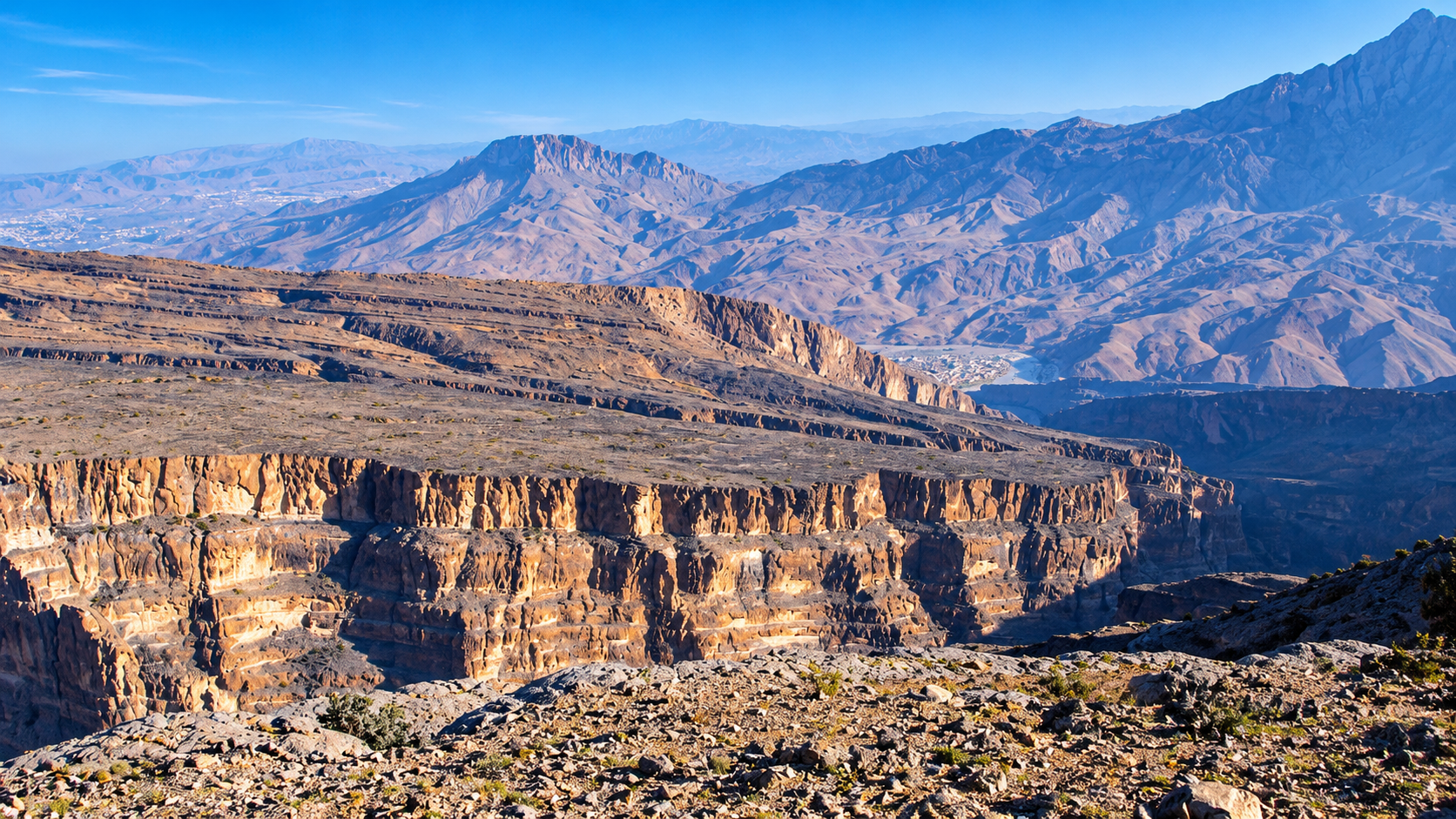 Dramatic panoramic view across the Oman Grand Canyon cliffs and mountain range at Jebel Shams
