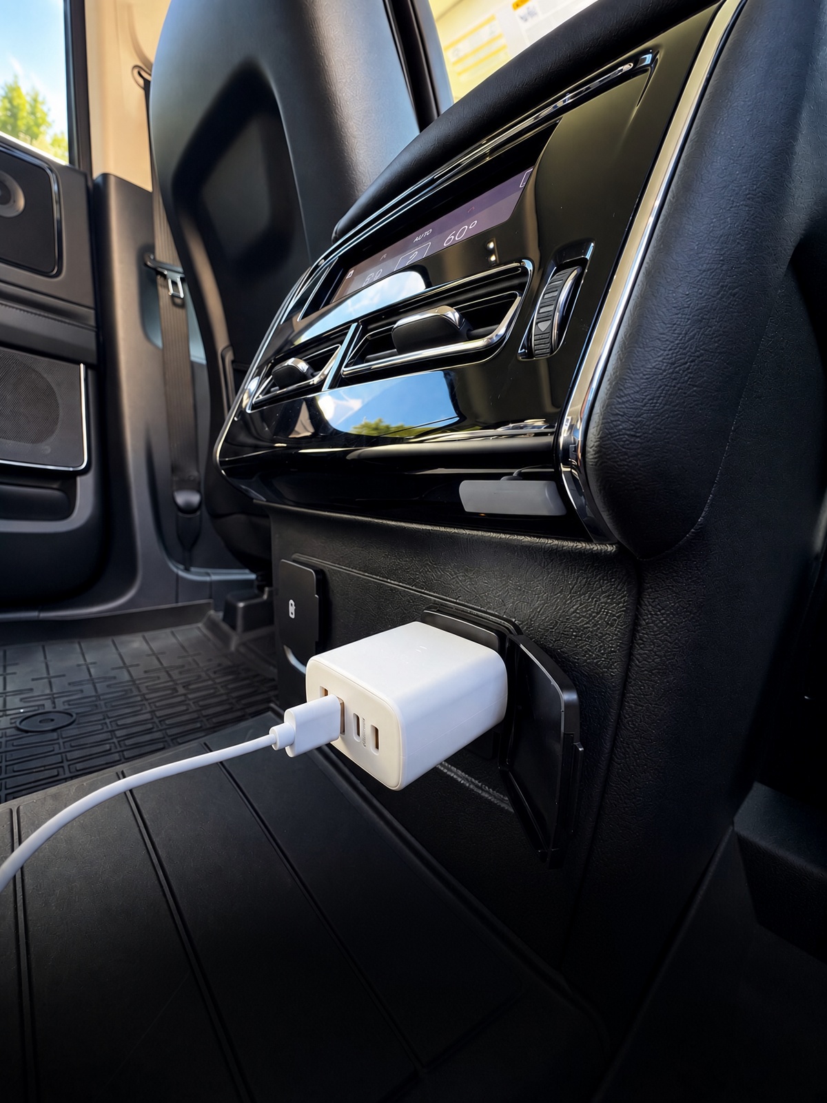 120V AC fast-charging power adapter plugged into rear console outlet