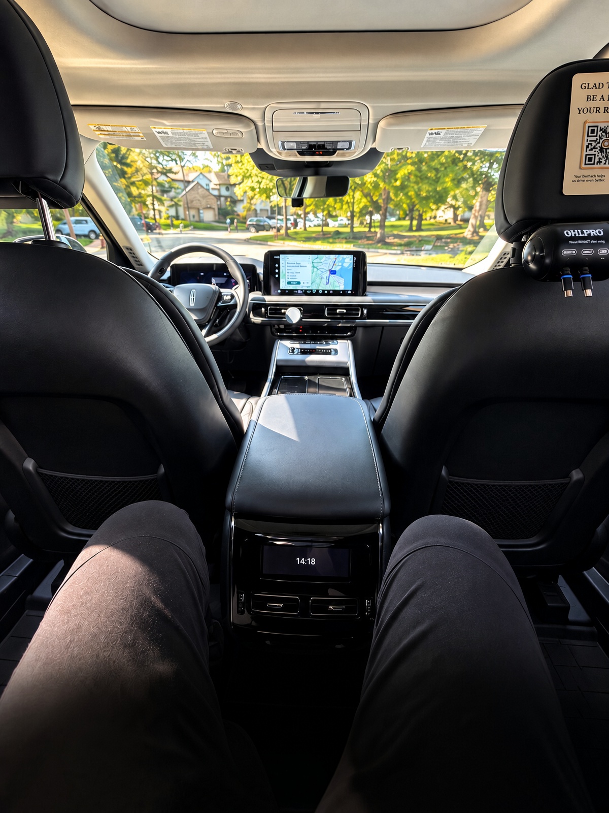 Passenger perspective stretching legs out in luxurious Lincoln Aviator rear seat: Sit Back. Stretch Out. Relax.