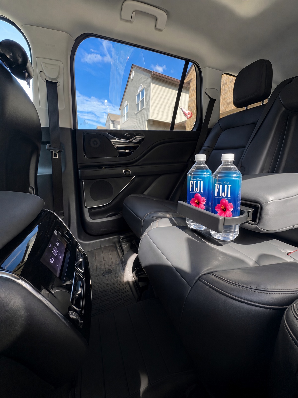 Chilled bottled water in Lincoln Aviator rear armrest cup holders