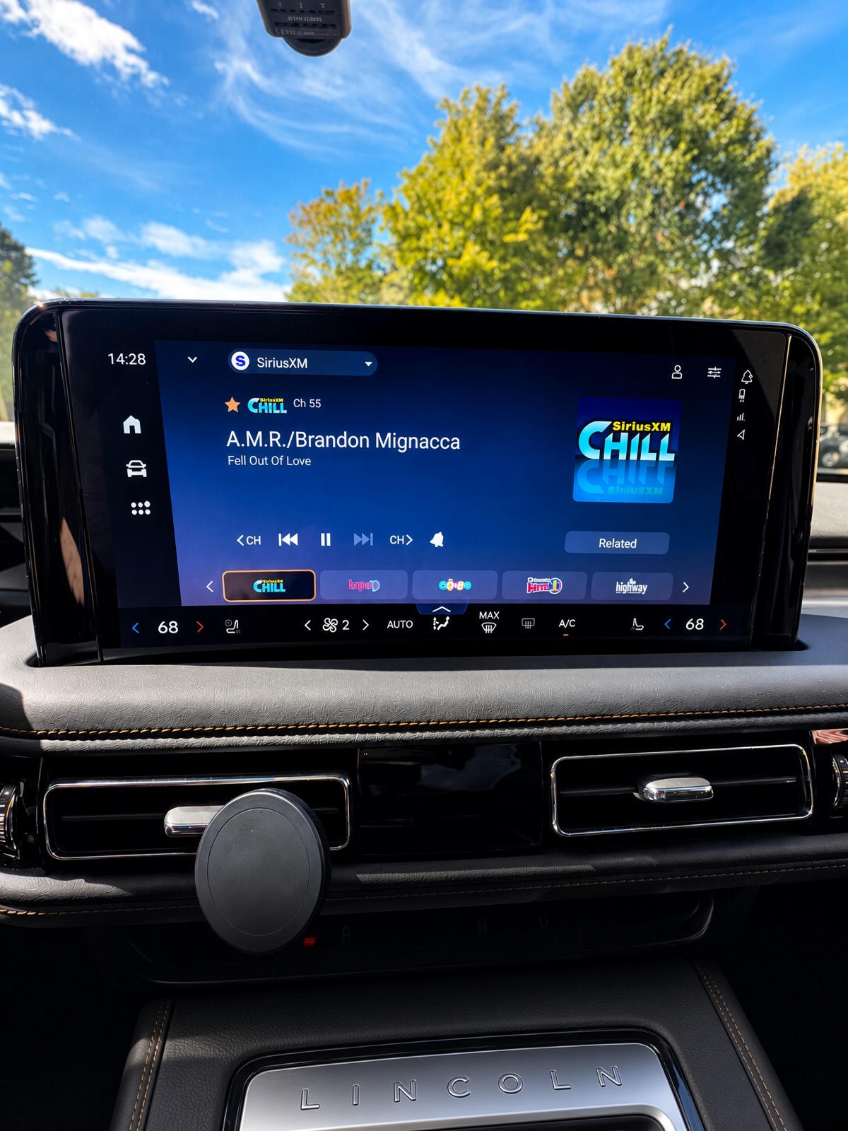 Passenger selecting SiriusXM satellite radio on Lincoln Aviator dashboard touch controls