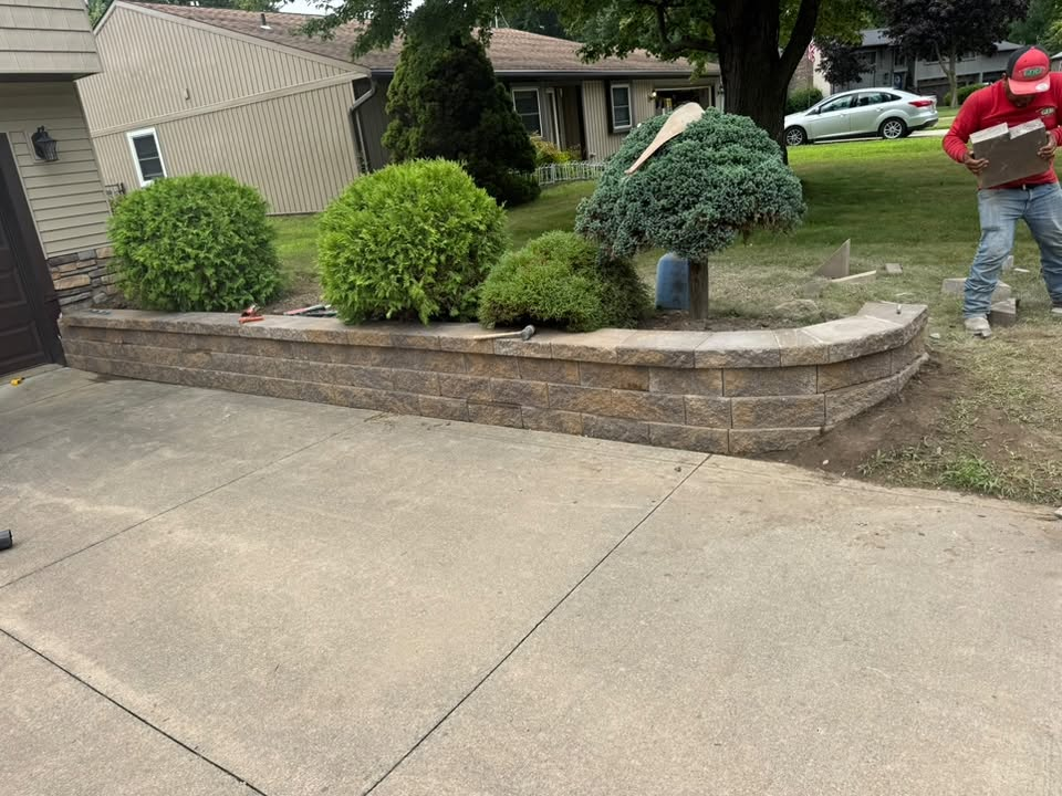 Curved Retaining Wall with Evergreen Shrub Bed