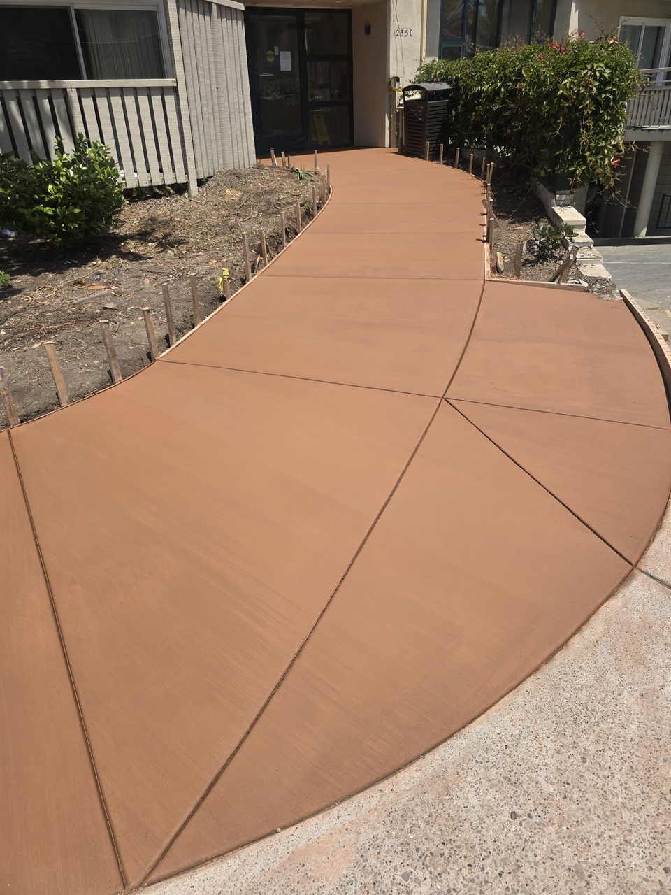 Finished Curved Terracotta Colored Concrete Sidewalk