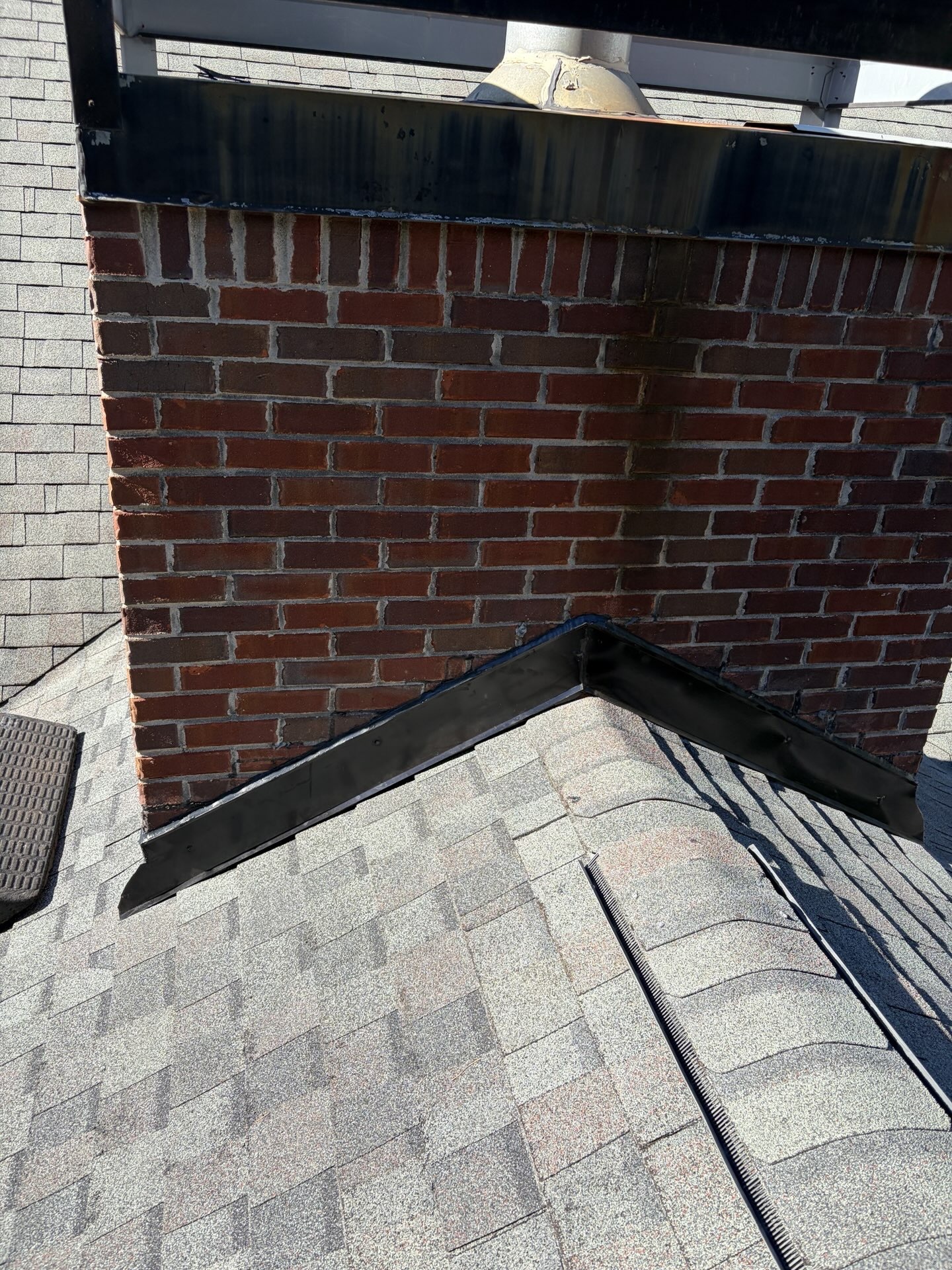 Chimney flashing repair on a brick chimney and shingle roof in Sharpsburg, GA