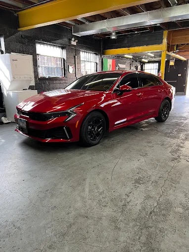 Cherry Red Sport Sedan in Shop Bay