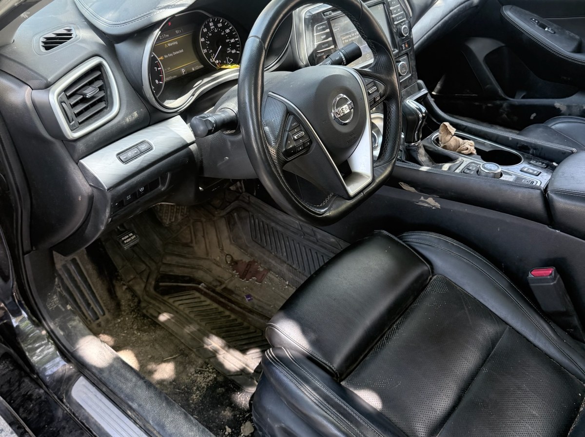 Before — Nissan Maxima front seat interior detail