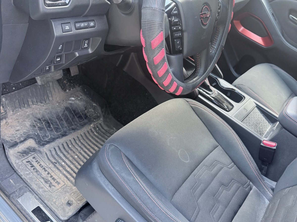 Before — Nissan Frontier front seat interior detail