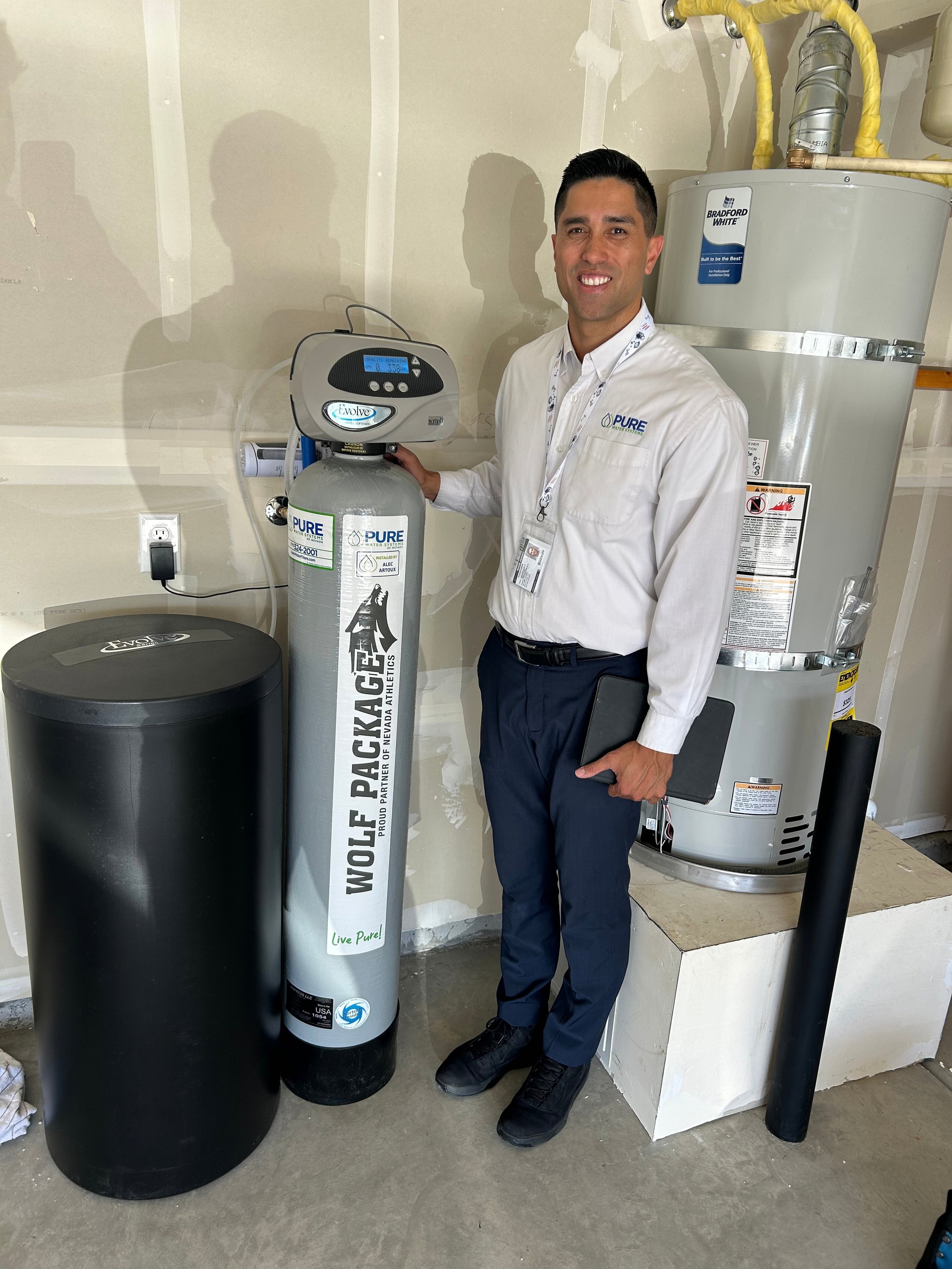 Kawika Burdine with a Wolf Package water softener installation in a Northern Nevada home