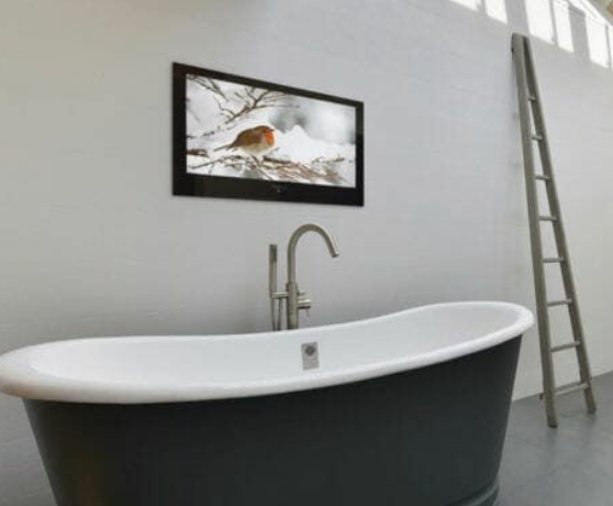 ProofVision waterproof bathroom TV installed above a freestanding bath