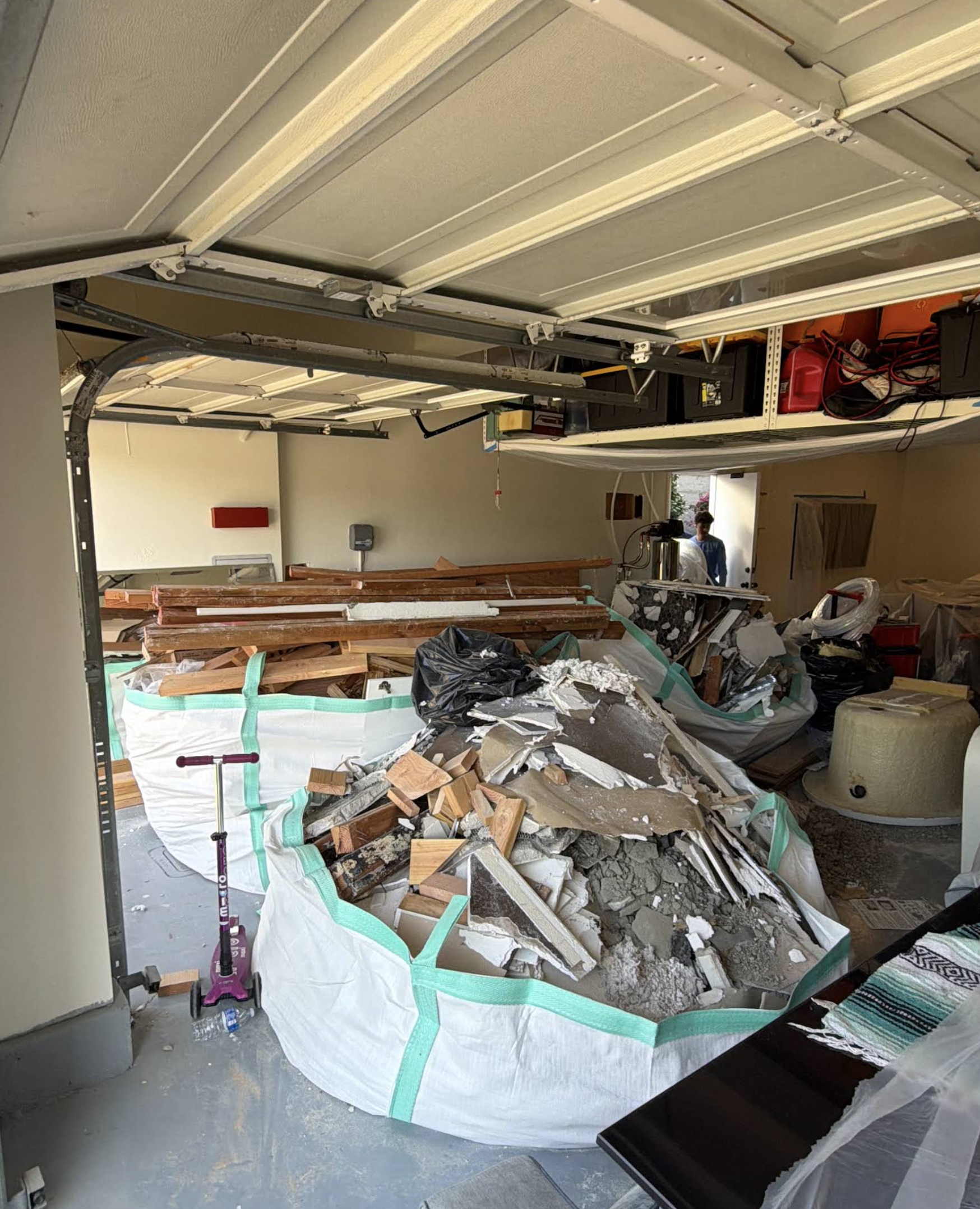 Garage cleanout and demolition waste packed into Eco Waste dumpster bags