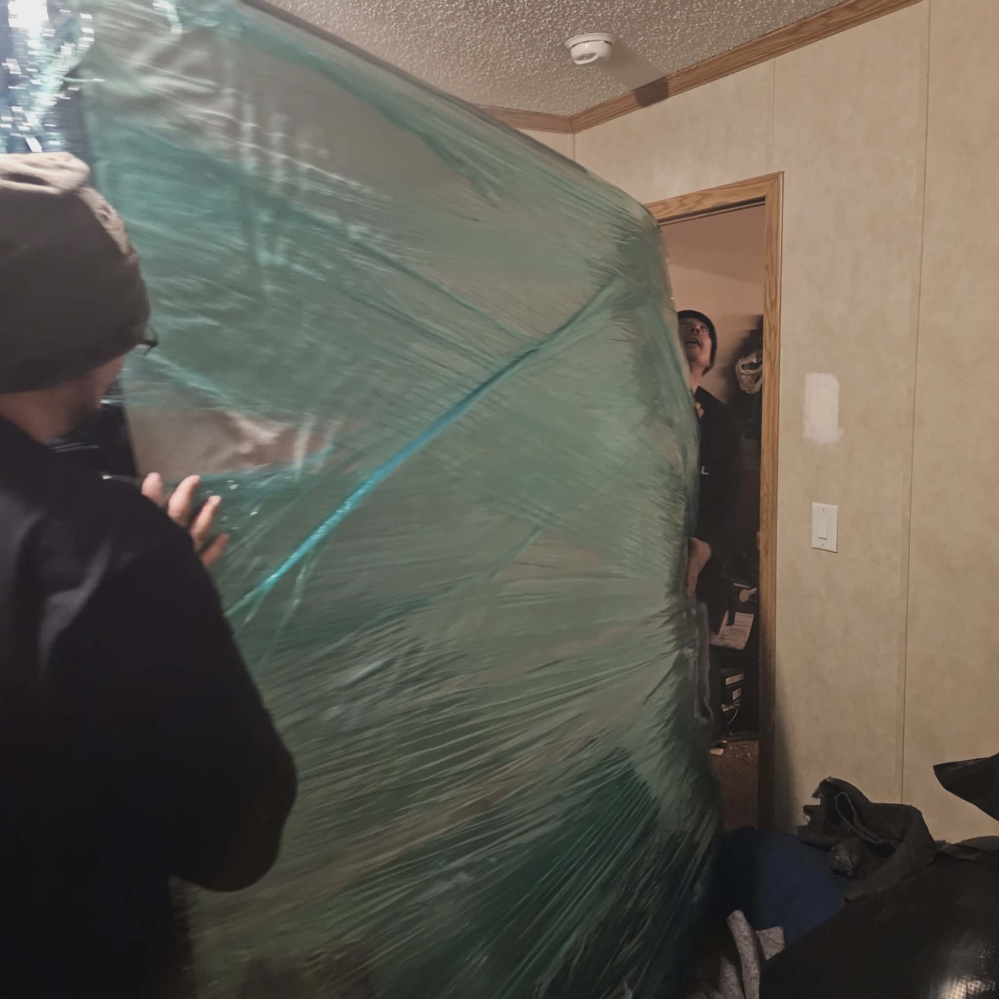 Painless Path Movers crew shrink-wrapping large furniture