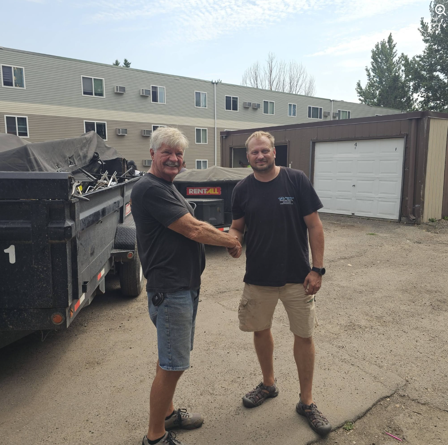 Painless Path Movers crew member shaking hands with client after a completed cleanout at College Park Apartments