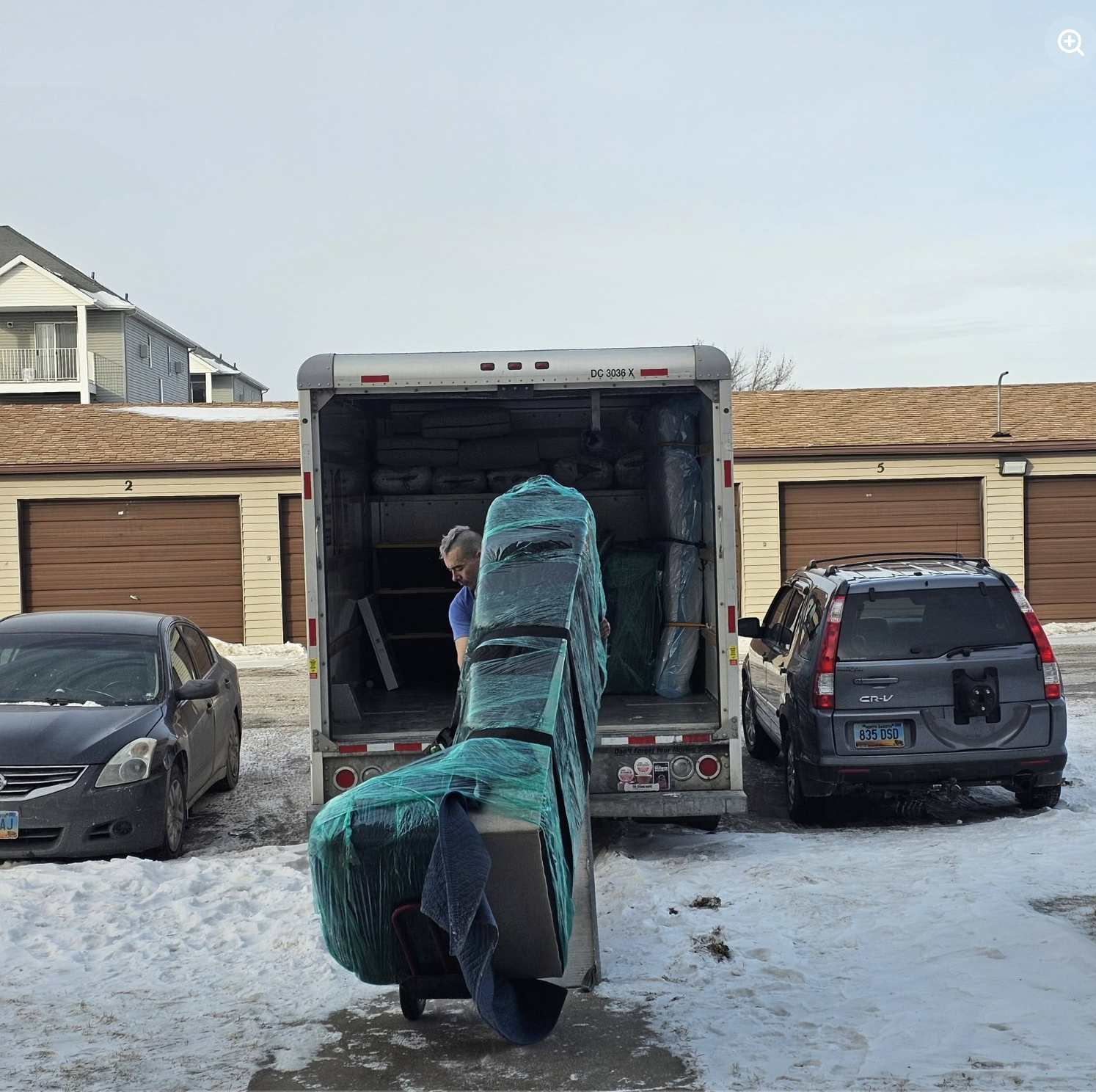 Painless Path mover moving fully padded and wrapped sofa down ramp into truck