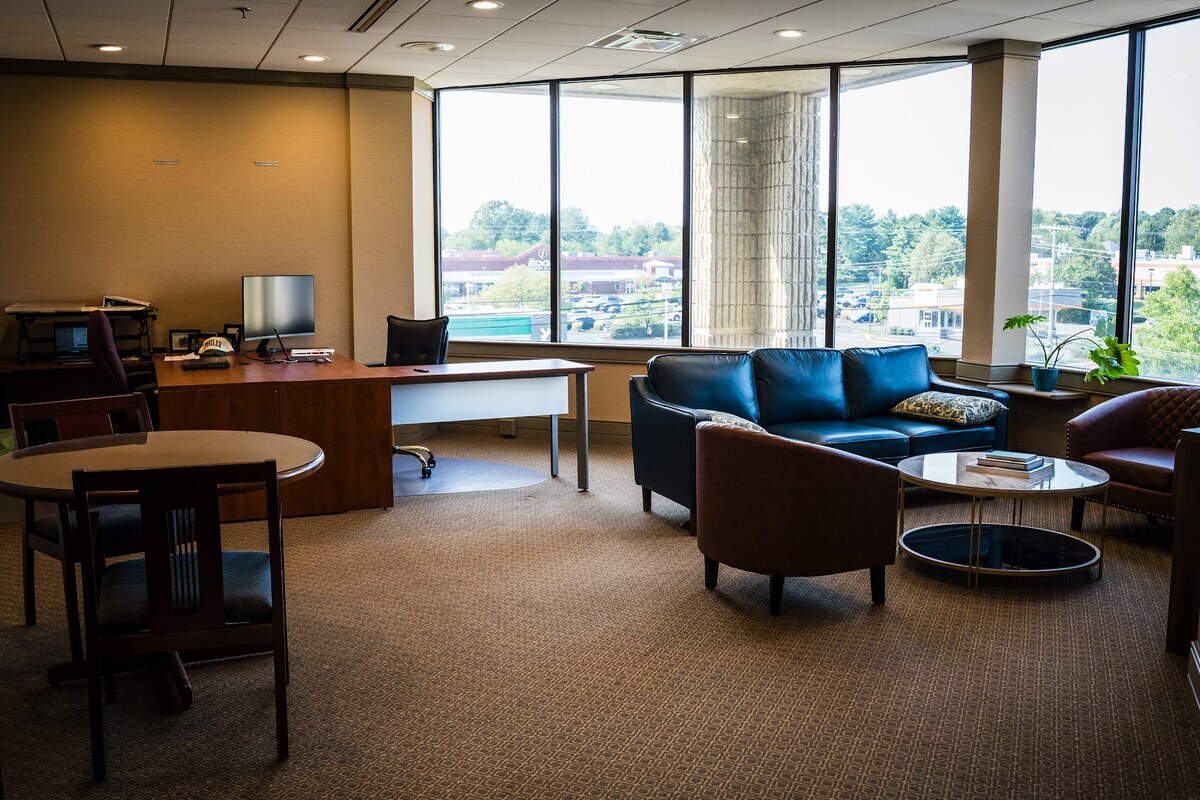 Furnished corner office with windows on two sides