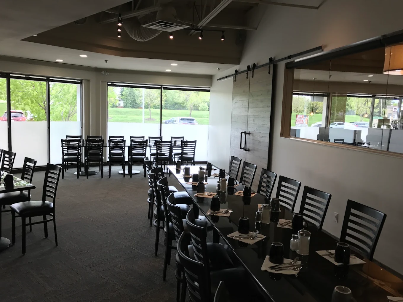 Headquarters Restaurant private dining room with large windows and banquet seating