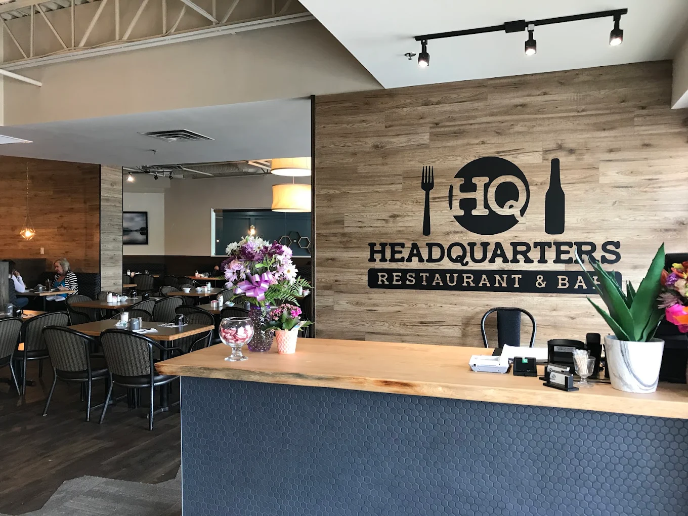 Welcoming reception desk and HQ brand wall at Headquarters