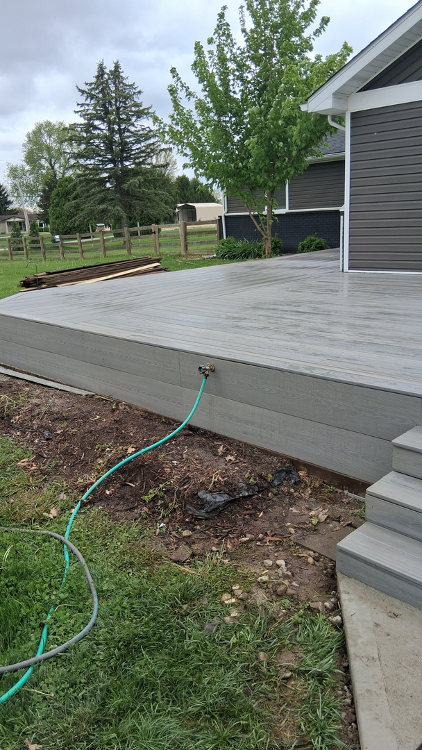 Crafted gray composite deck with finished fascia boards and steps