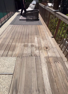 Real outdoor project — sun-weathered deck board inspection and prep
