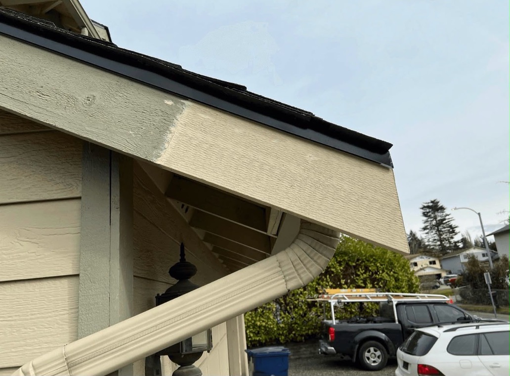 Fresh fascia splice repair before paint along eave with new metal flashing and gutter