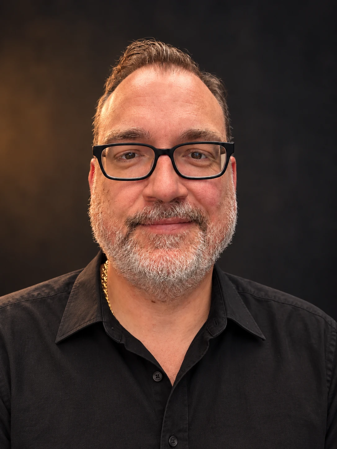 Cory O’Grodnik wearing black glasses and a black collared shirt