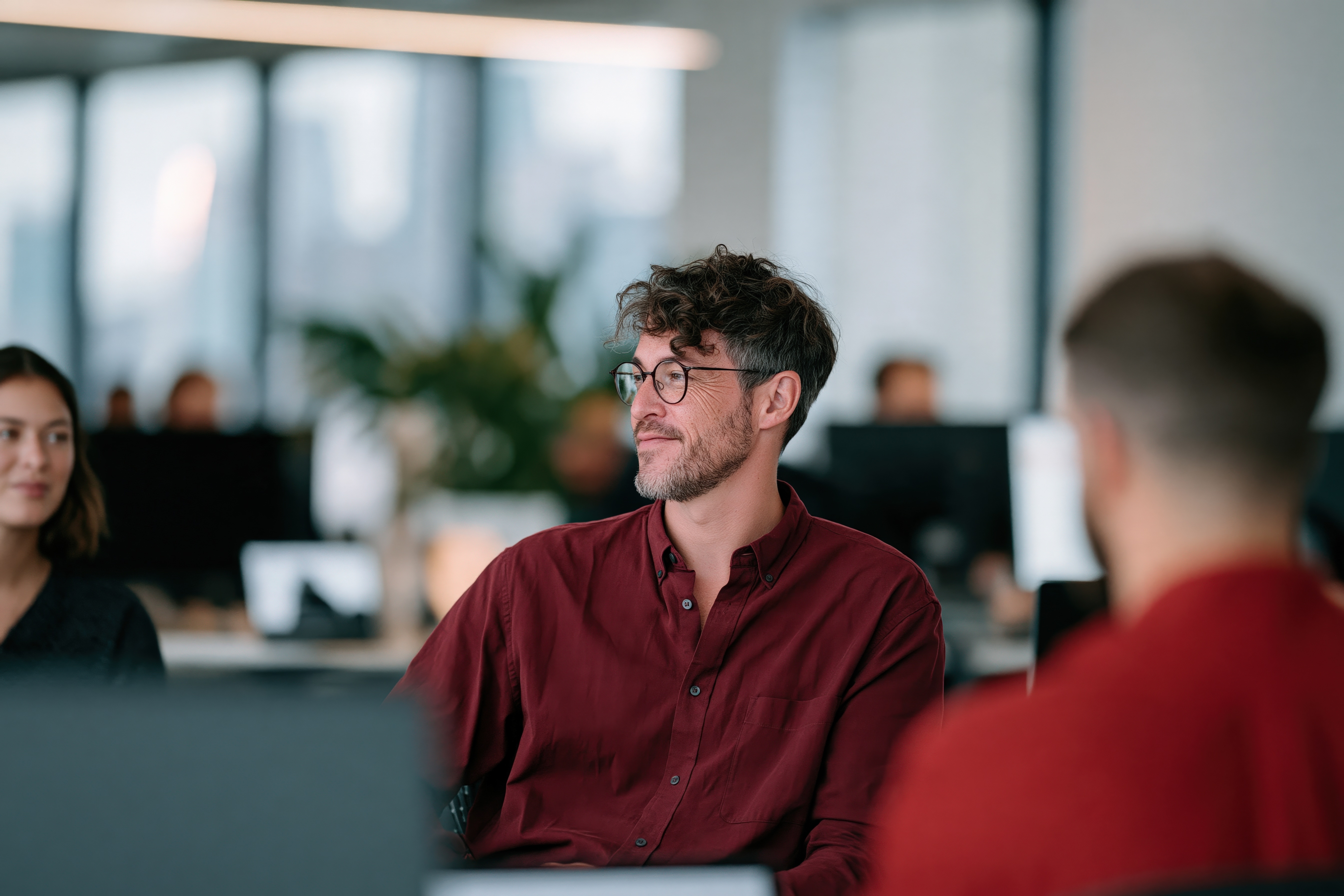 Team member listening in an office meeting with colleagues