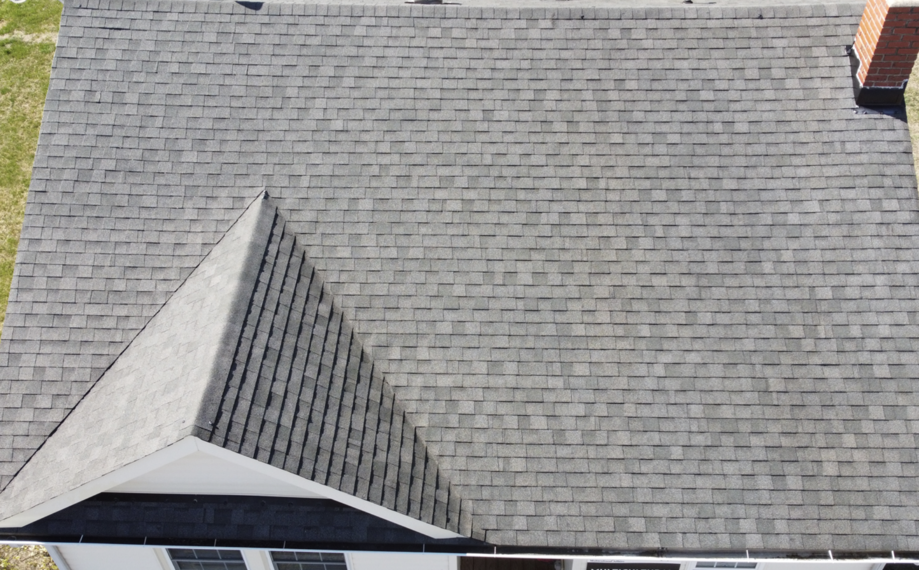 Close-up of asphalt shingles restored after Replenish roof rejuvenation treatment