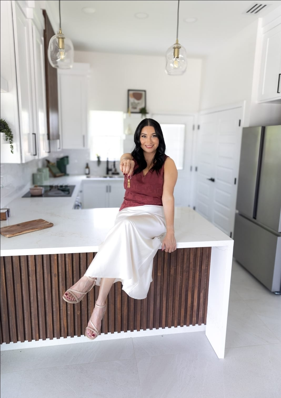 Mari Garza holding out the keys to your next home in Hidalgo County