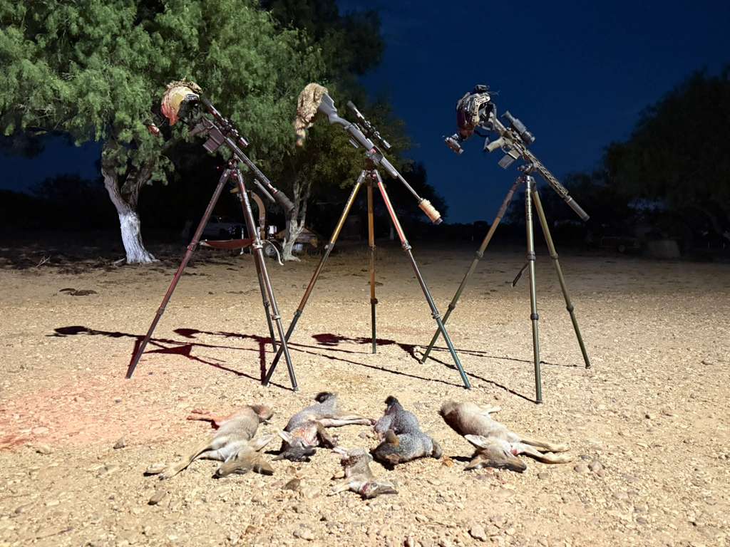 Hunting team with thermals and suppressed rifles by the truck, gear visible