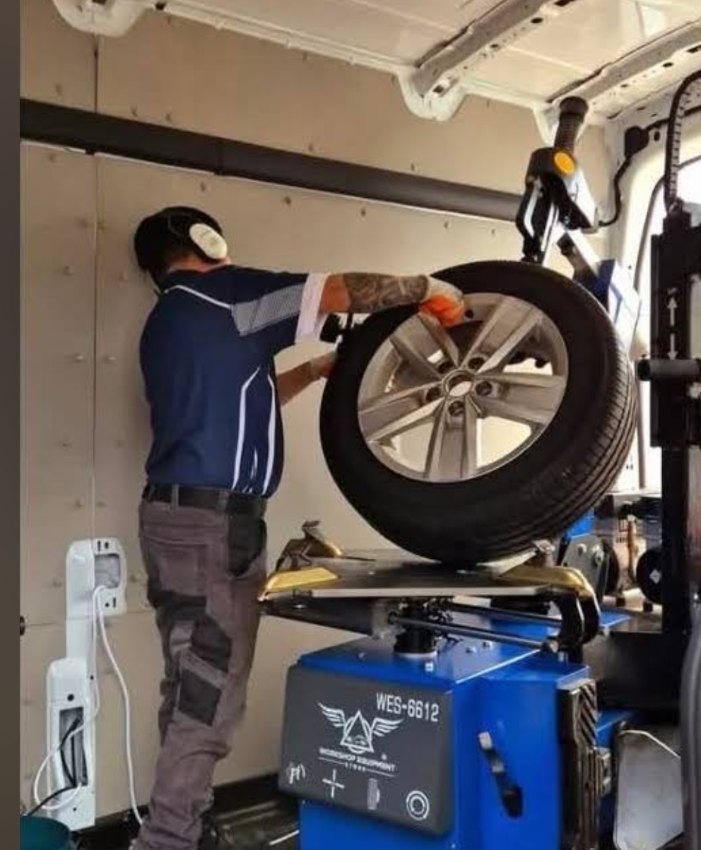 Inside Big J mobile workshop van using precision tyre mounting and balancing machinery