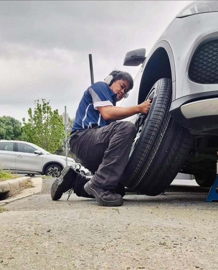 Big J mobile tyre technician changing tyre directly at customer location in Harkness