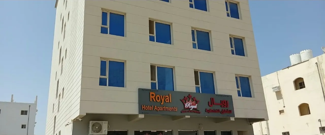 Close-up of the Royal Hotel Apartments facade with the Royal sign, Al Amerat