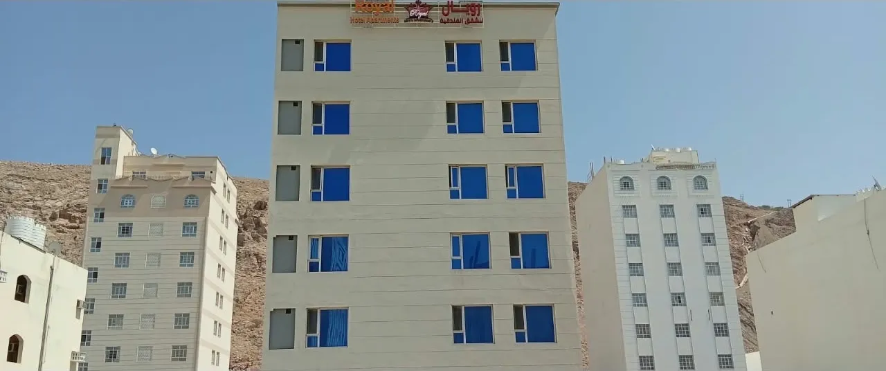 Full Royal Hotel Apartments building against a blue sky, Al Amerat