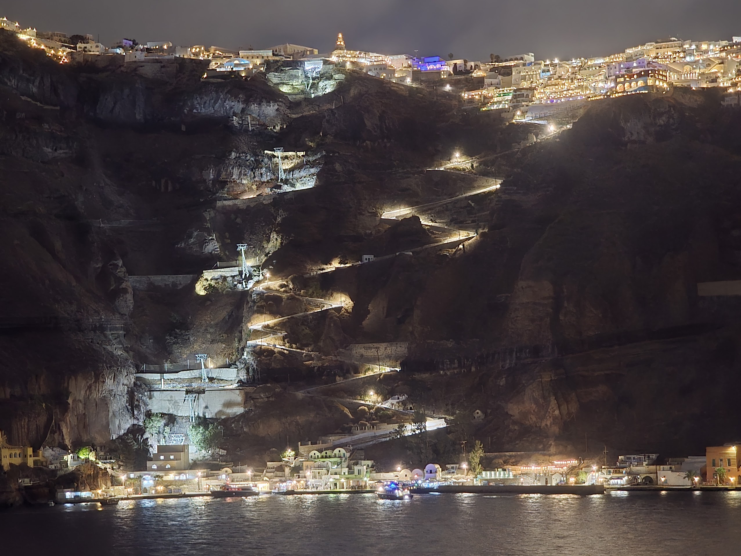 Santorini caldera cliffside and winding illuminated steps at night