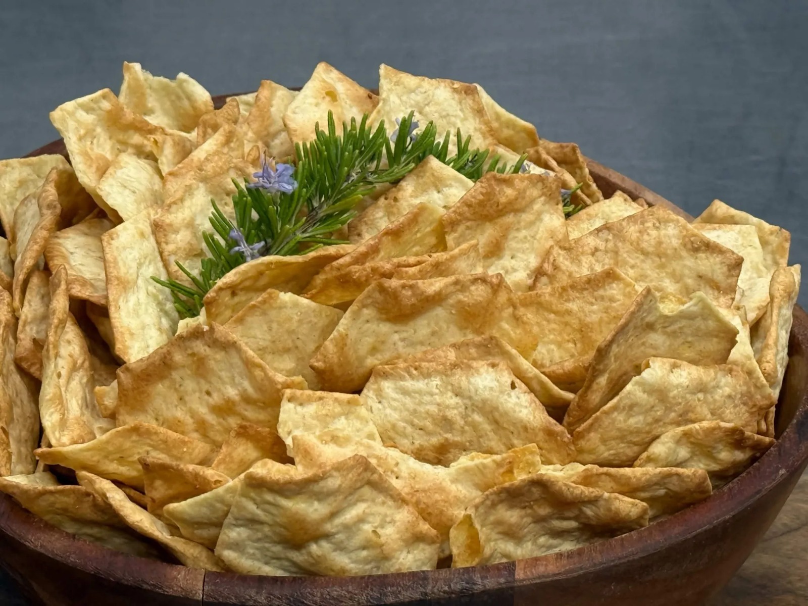 Golden Crispy Housemade Totopos & Crackers in Rustic Wooden Bowl