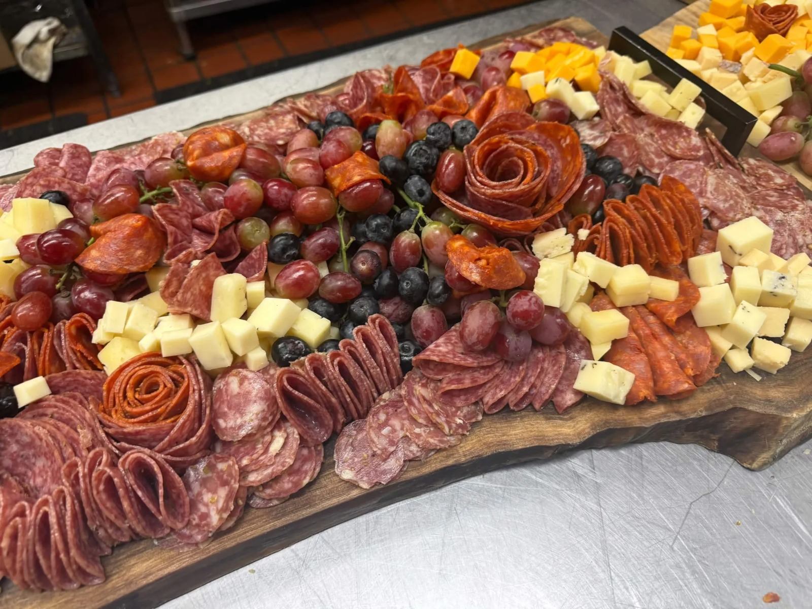 Artisanal Charcuterie Board with Salami Rosettes, Cheeses & Grapes