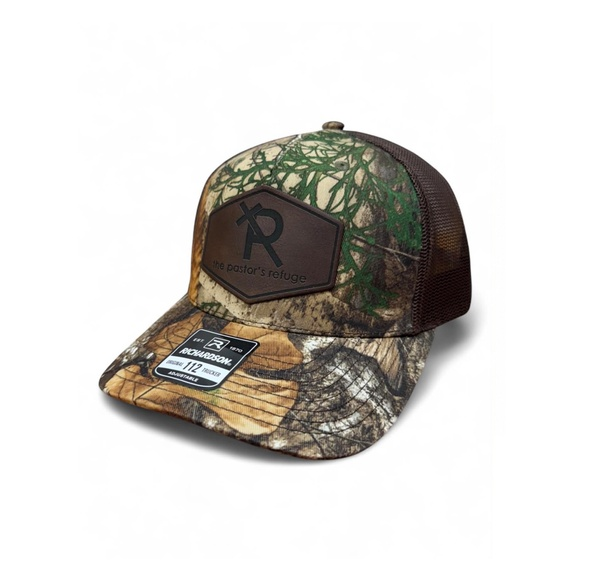 The Pastor's Refuge Richardson 112 camo trucker hat with embossed leather patch