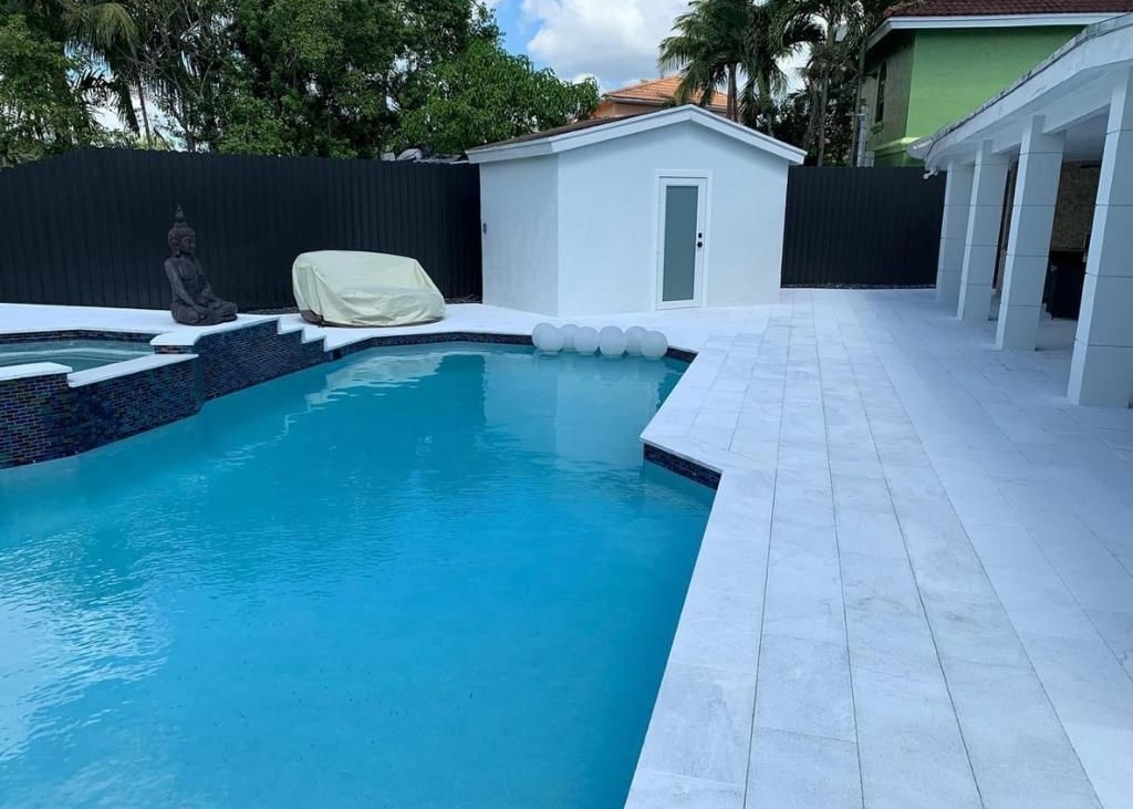 Completed Precision pool project showing the relationship between the pool edge, waterline tile, raised feature, and surrounding deck