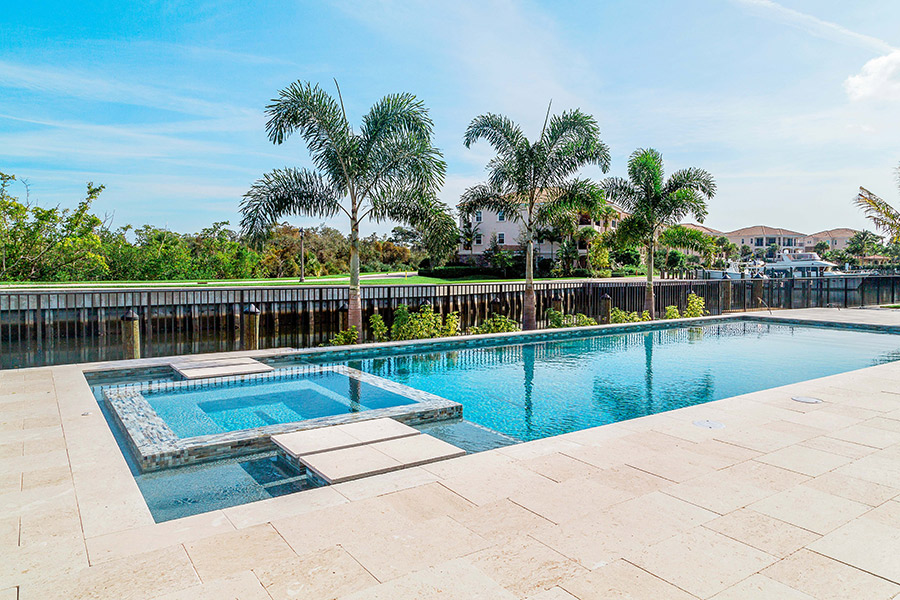 Completed Precision pool project showing a defined pool edge coordinating with the surrounding deck and raised spa