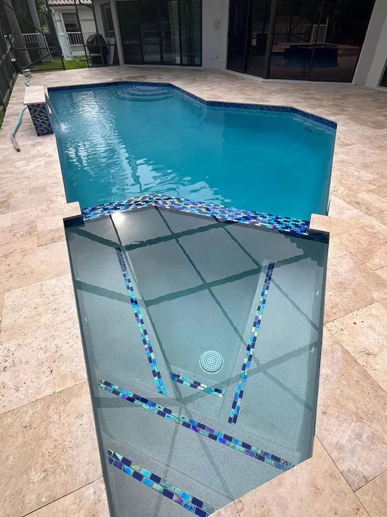 Authentic Precision pool project showing the relationship between the interior finish, decorative tile, coping, and surrounding deck