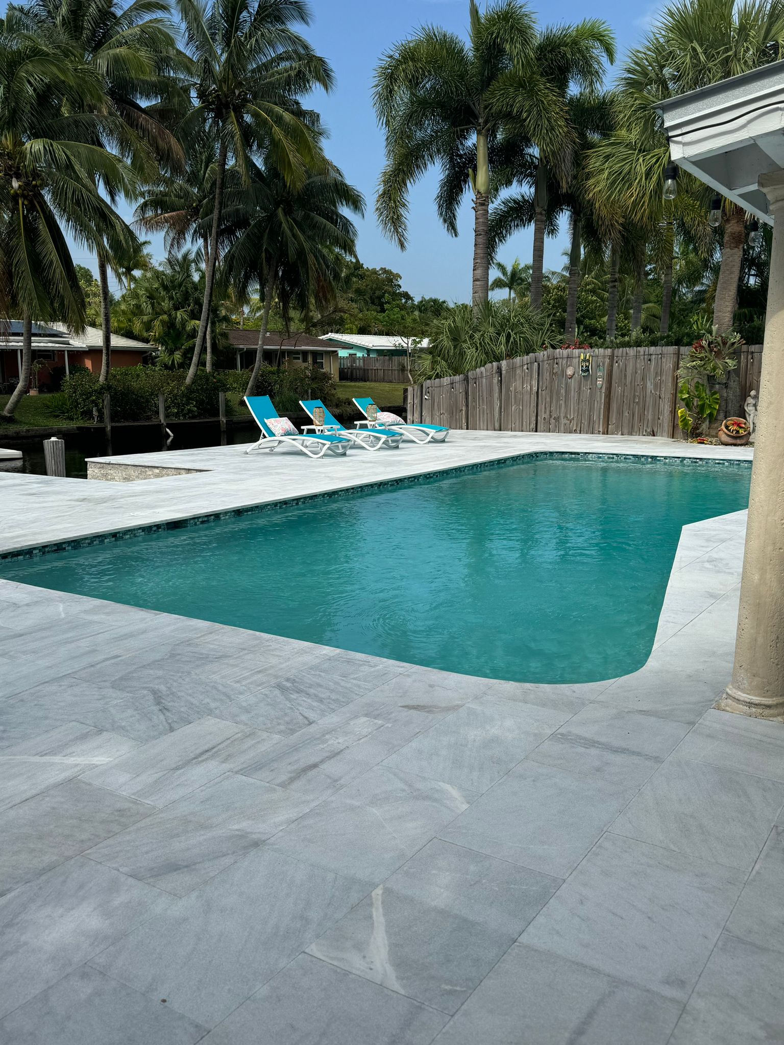 Completed Precision pool project with coordinated waterline tile, coping, and light-colored surrounding deck