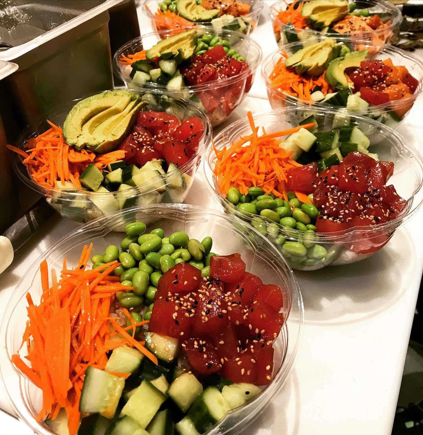 Freshly prepped ahi tuna poke bowls with avocado, edamame, cucumber, and shredded carrots at Nori in Omaha