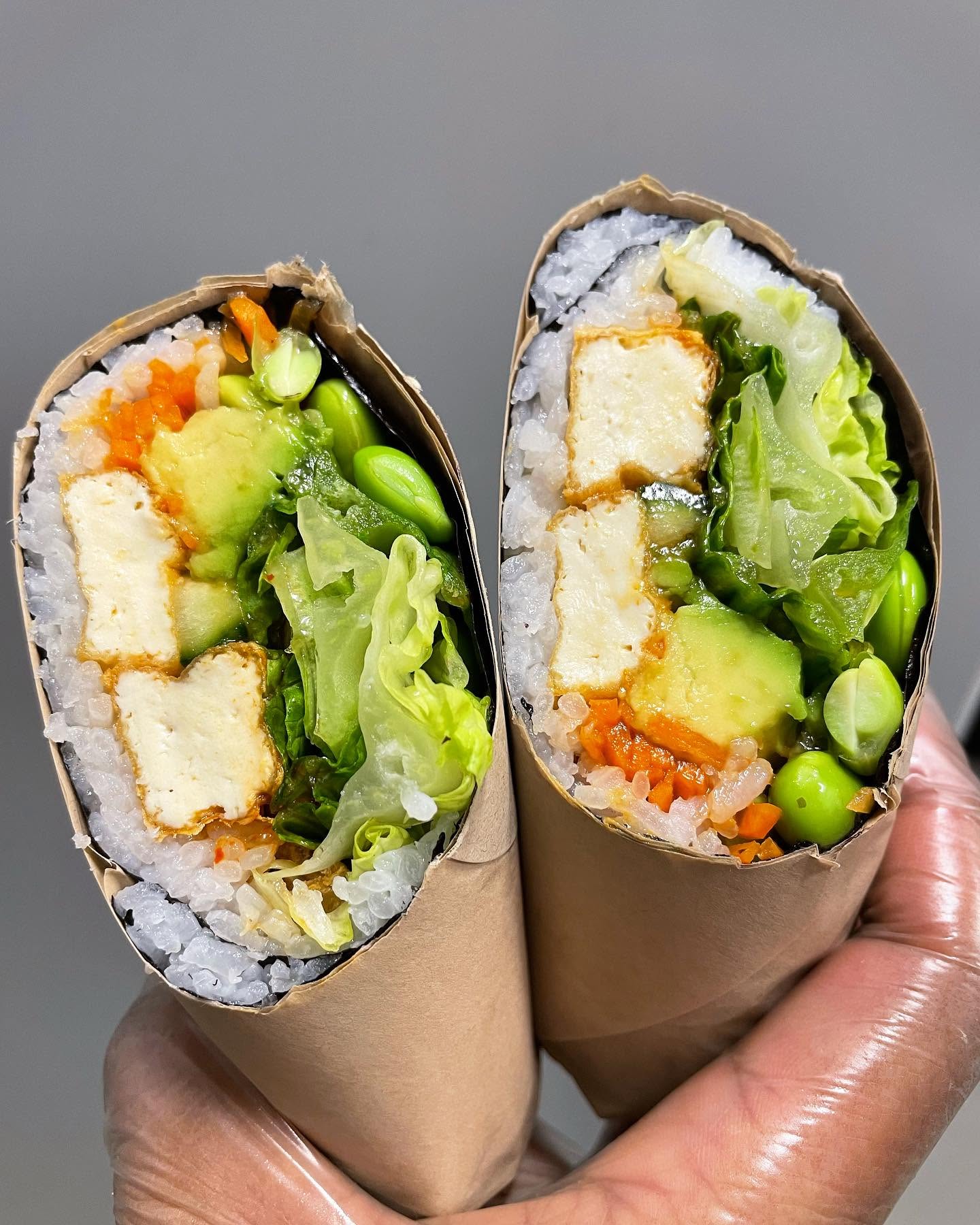 Handcrafted tofu and fresh vegetable sushi roll wrap cut in halves at Nori in Omaha