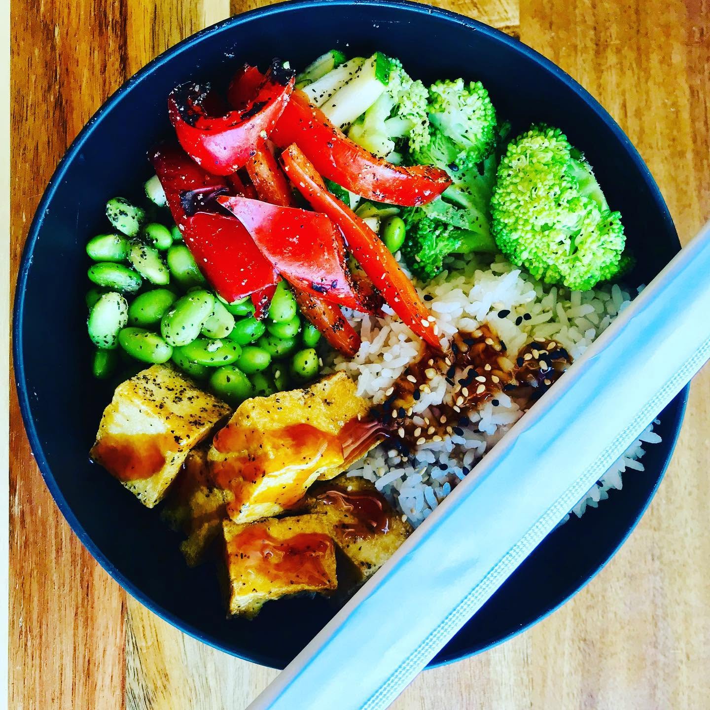 Tofu teriyaki bowl with charred peppers, edamame, and broccoli over rice at Nori in Omaha