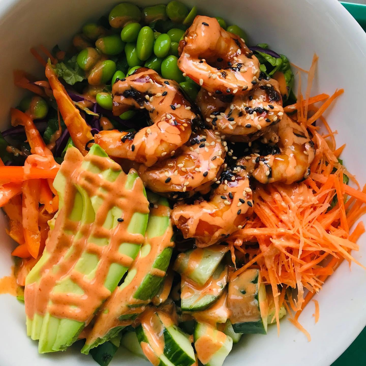 Glazed shrimp poke bowl with spicy aioli, sliced avocado, edamame, and shredded carrots at Nori in Omaha