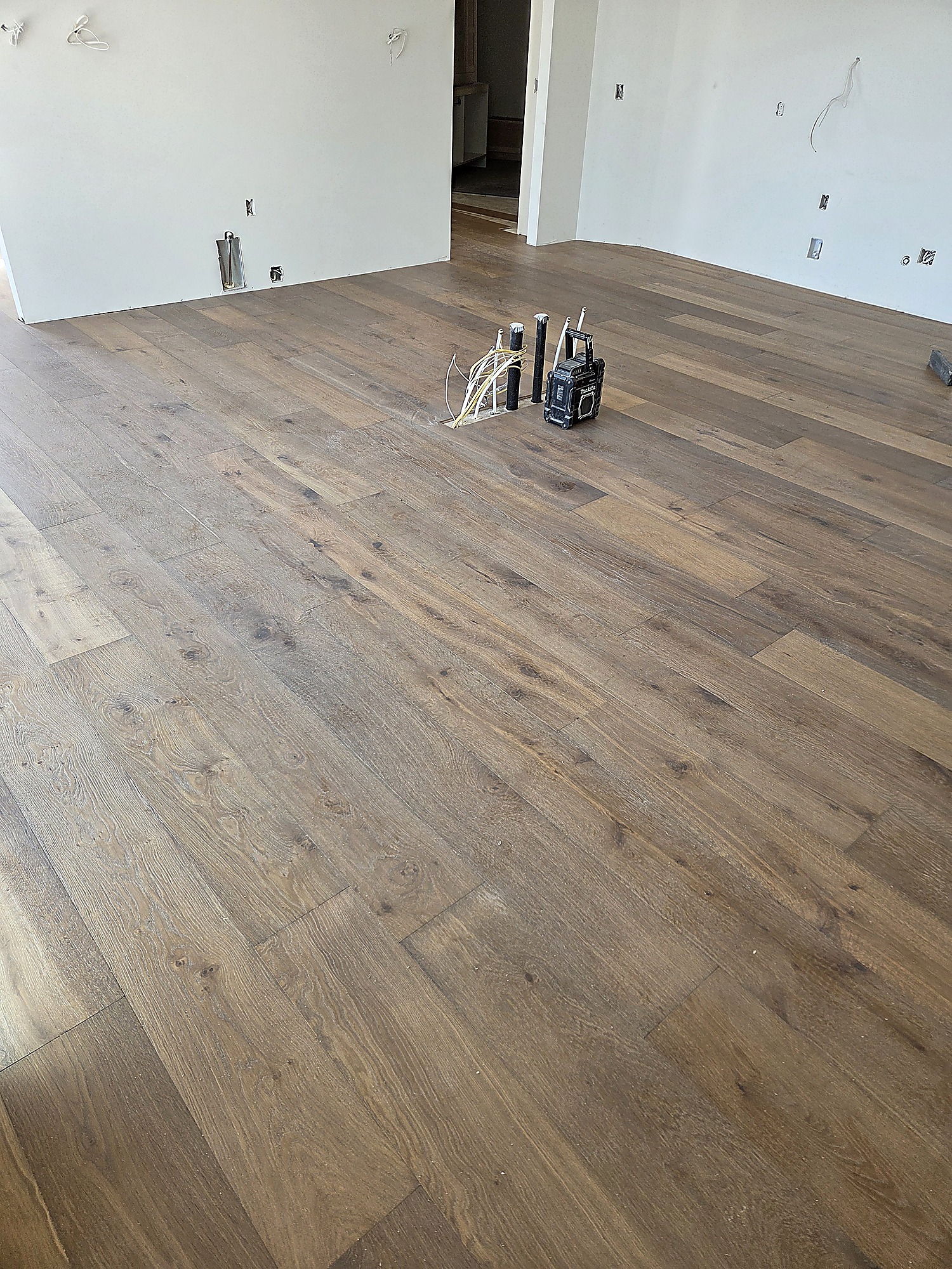 Engineered hardwood flooring in a sunlit loft with lake views